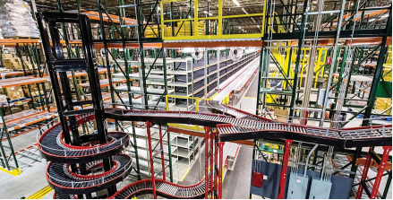 A large warehouse with state-of-the-art palletizing automation and a stunning spiral staircase.