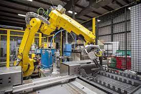 Engineered Solutions: A robot is meticulously working on a machine in a factory.
